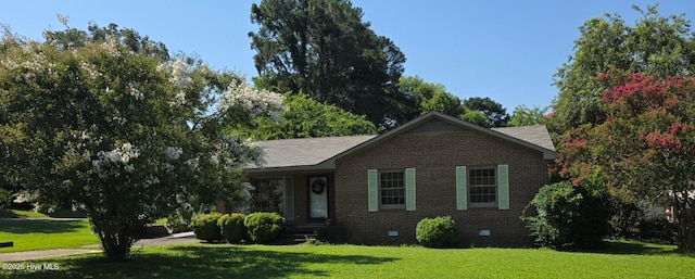 302 Bunche Dr, Goldsboro, NC 27530 - view of front facade with brick siding, a front lawn, and crawl space
