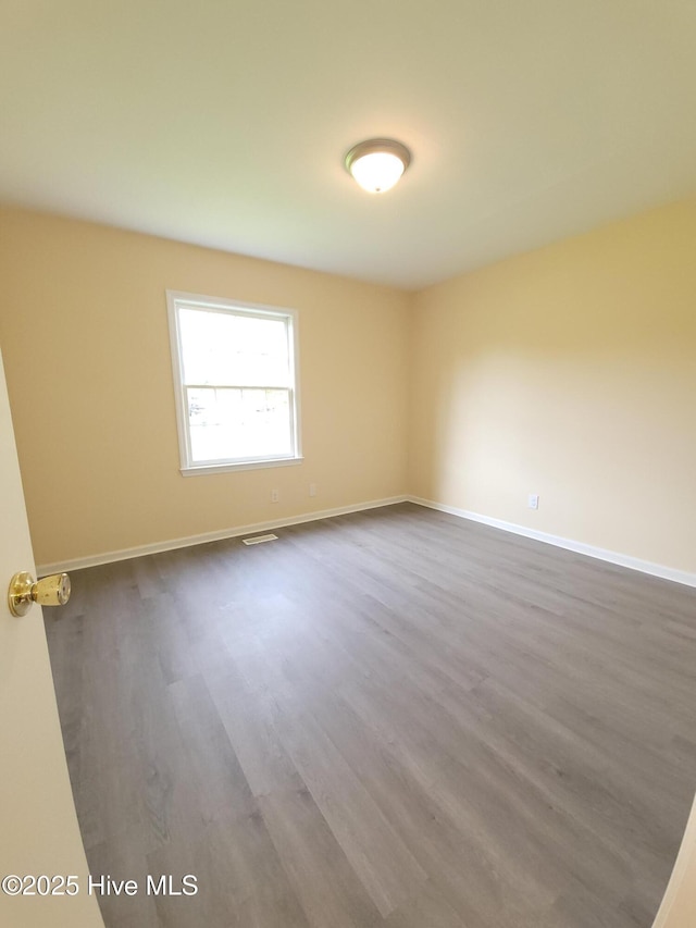 302 Bunche Dr, Goldsboro, NC 27530 - spare room with dark wood finished floors and baseboards