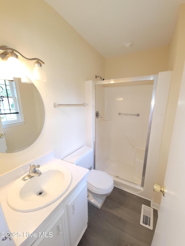 302 Bunche Dr, Goldsboro, NC 27530 - bathroom with a stall shower, vanity, and wood finished floors