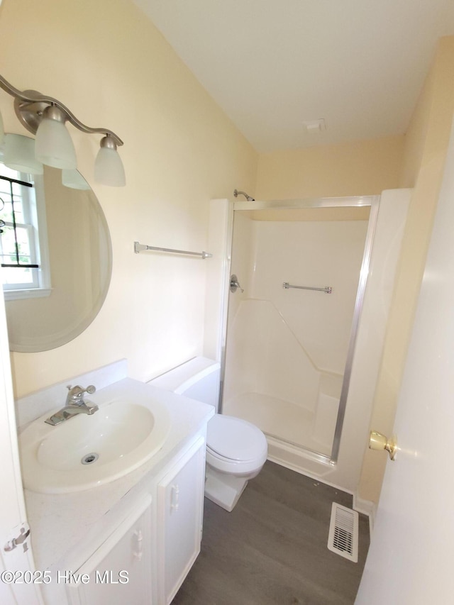 302 Bunche Dr, Goldsboro, NC 27530 - full bathroom with a stall shower, vanity, and wood finished floors