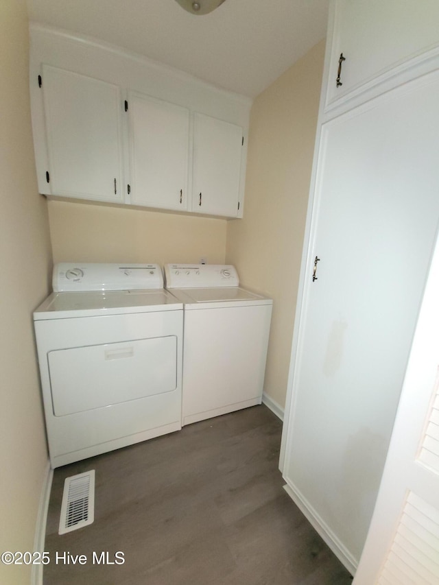 302 Bunche Dr, Goldsboro, NC 27530 - laundry room featuring cabinet space, dark wood-style floors, and separate washer and dryer
