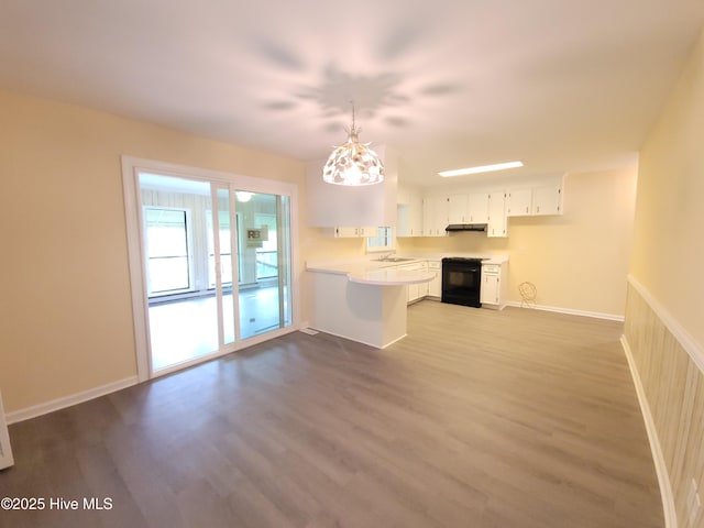 302 Bunche Dr, Goldsboro, NC 27530 - unfurnished living room with dark wood-type flooring and a chandelier