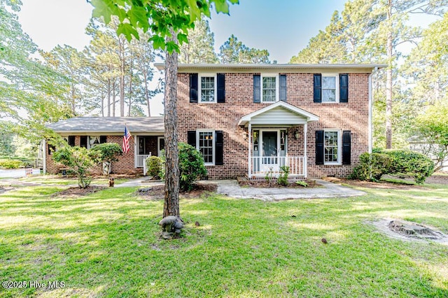 100 E Hedgelawn Way, Southern Pines, NC 28387 - colonial home featuring brick siding and a front lawn