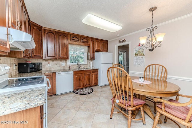 100 E Hedgelawn Way, Southern Pines, NC 28387 - kitchen with white appliances, exhaust hood, backsplash, pendant lighting, and crown molding