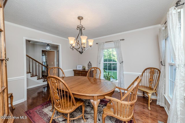 100 E Hedgelawn Way, Southern Pines, NC 28387 - dining area featuring a chandelier, wood finished floors, a textured ceiling, stairs, and crown molding