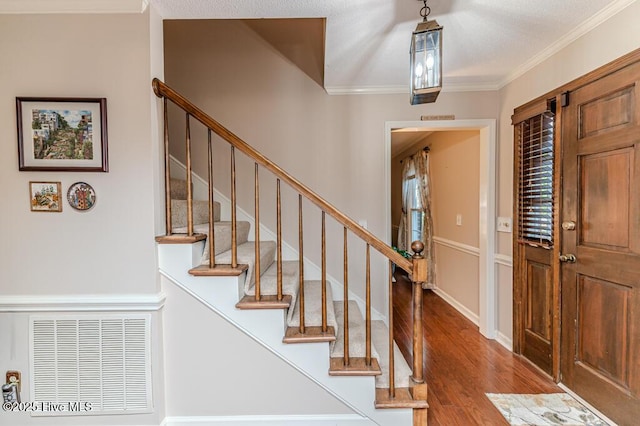 100 E Hedgelawn Way, Southern Pines, NC 28387 - entryway featuring wood finished floors, stairs, and crown molding
