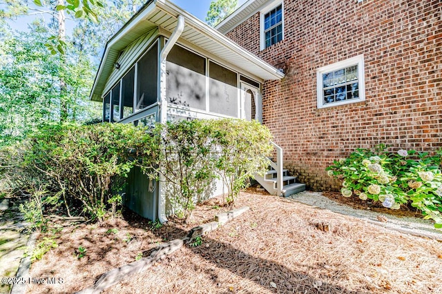 100 E Hedgelawn Way, Southern Pines, NC 28387 - view of side of home with a sunroom and brick siding