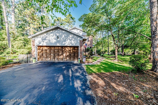 100 E Hedgelawn Way, Southern Pines, NC 28387 - view of home's exterior featuring brick siding and driveway