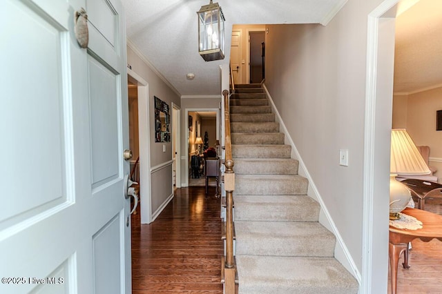 100 E Hedgelawn Way, Southern Pines, NC 28387 - entrance foyer with dark wood-style flooring, ornamental molding, and stairway