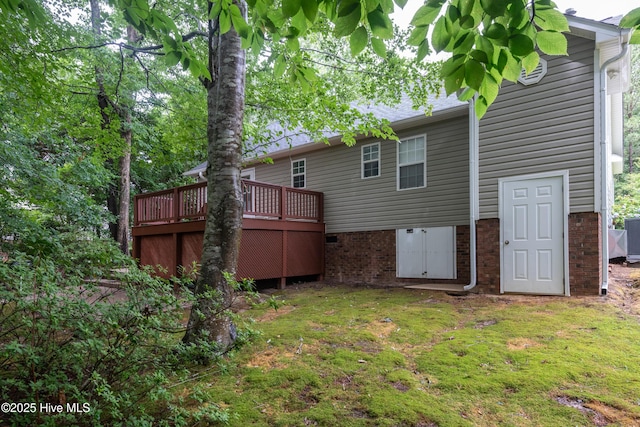 347 Stone Gate Dr, Greenville, NC 27858 - back of property with a deck, a yard, and brick siding