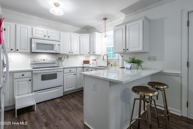 347 Stone Gate Dr, Greenville, NC 27858 - kitchen with white appliances, a peninsula, white cabinets, dark wood-style flooring, and ornamental molding