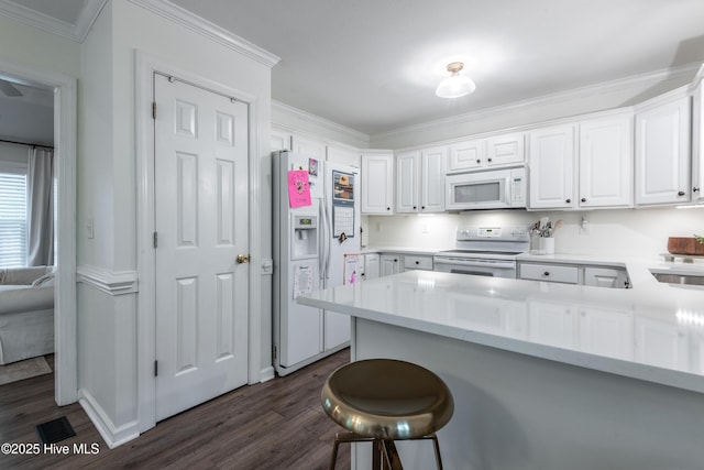 347 Stone Gate Dr, Greenville, NC 27858 - kitchen featuring white appliances, dark wood-type flooring, white cabinets, crown molding, and a peninsula