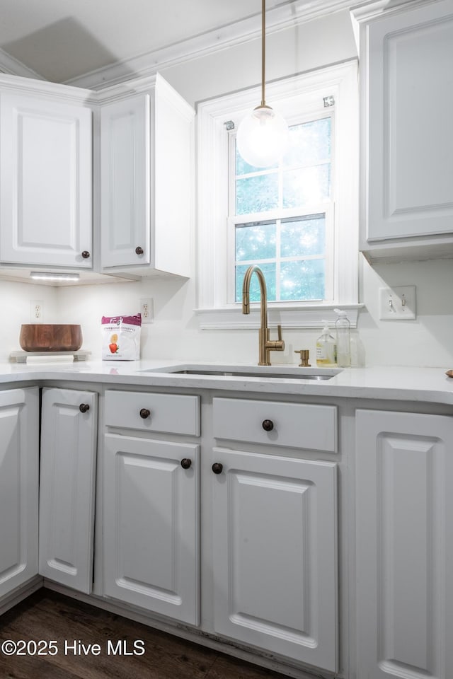 347 Stone Gate Dr, Greenville, NC 27858 - kitchen with white cabinetry, light countertops, and decorative light fixtures