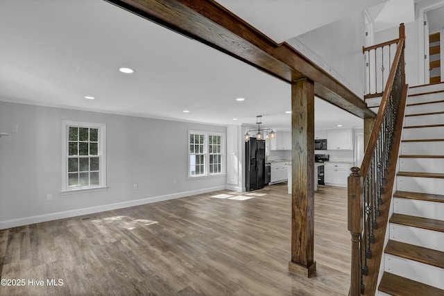 2971 Penderlea Hwy, Burgaw, NC 28425 - unfurnished living room with recessed lighting, stairs, a chandelier, and wood finished floors