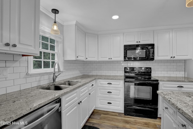 2971 Penderlea Hwy, Burgaw, NC 28425 - kitchen with black appliances, white cabinetry, decorative light fixtures, wood finished floors, and tasteful backsplash