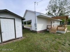 204 Mercer St, Goldsboro, NC 27530 - rear view of house with a lawn, a wooden deck, and a storage shed