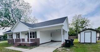 204 Mercer St, Goldsboro, NC 27530 - view of front of house with a porch, a storage shed, concrete driveway, a front yard, and a carport
