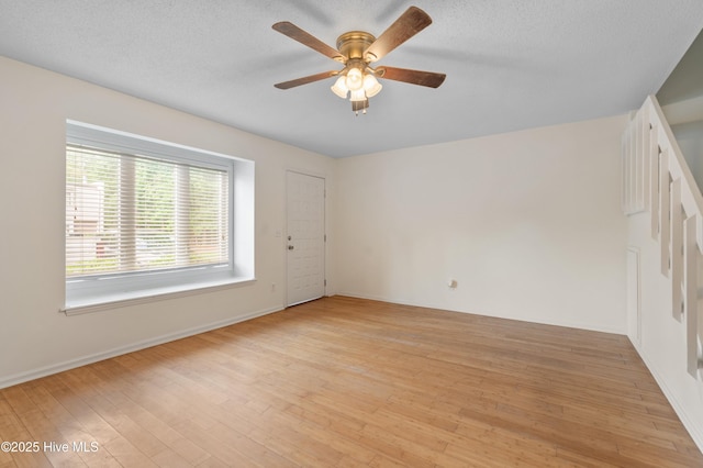 514 Cobblestone Dr, Wilmington, NC 28405 - unfurnished room with ceiling fan, light wood-style floors, and a textured ceiling
