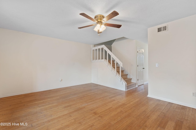 514 Cobblestone Dr, Wilmington, NC 28405 - empty room featuring stairs, ceiling fan, and light wood-style flooring