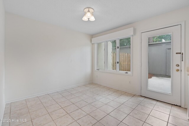 514 Cobblestone Dr, Wilmington, NC 28405 - empty room featuring light tile patterned floors and baseboards
