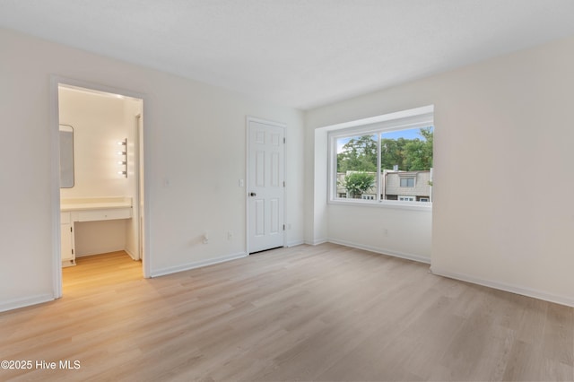 514 Cobblestone Dr, Wilmington, NC 28405 - unfurnished bedroom featuring light wood-style flooring and ensuite bathroom