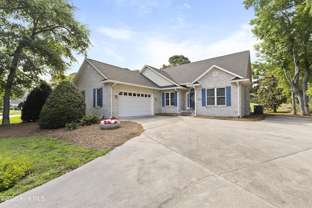 102 Crooked Gulley Cir, Sunset Beach, NC 28468 - ranch-style home featuring concrete driveway, a garage, brick siding, and a shingled roof
