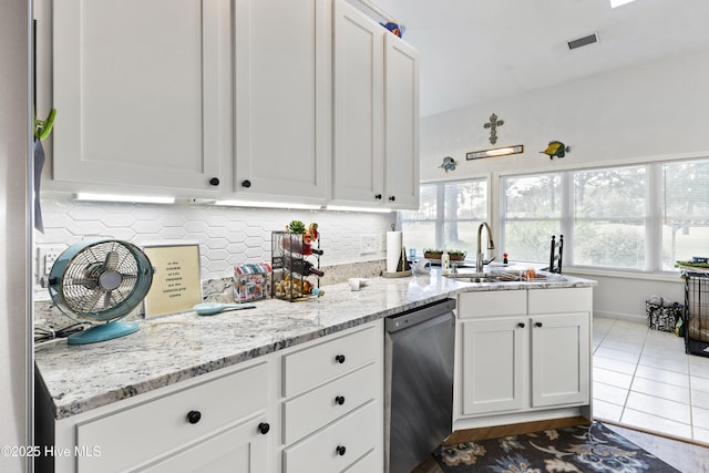 102 Crooked Gulley Cir, Sunset Beach, NC 28468 - kitchen featuring dishwasher, white cabinetry, decorative backsplash, and light stone countertops