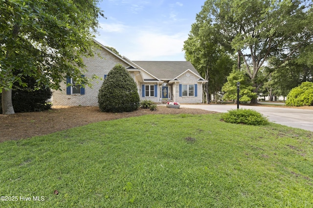 102 Crooked Gulley Cir, Sunset Beach, NC 28468 - view of front of property featuring brick siding, a front lawn, and driveway