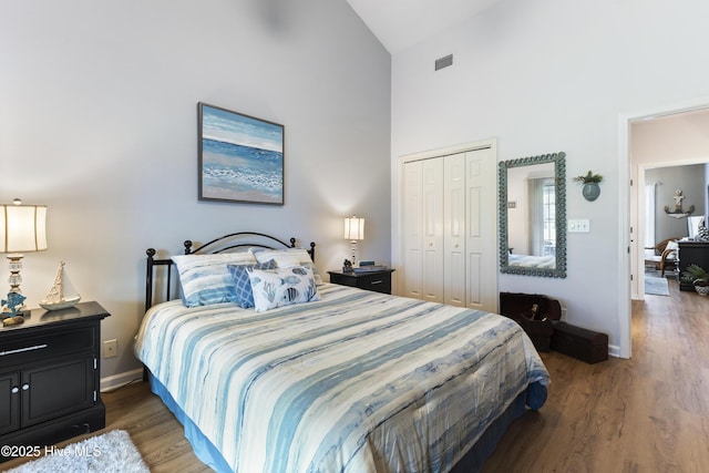 102 Crooked Gulley Cir, Sunset Beach, NC 28468 - bedroom with high vaulted ceiling, a closet, and wood finished floors