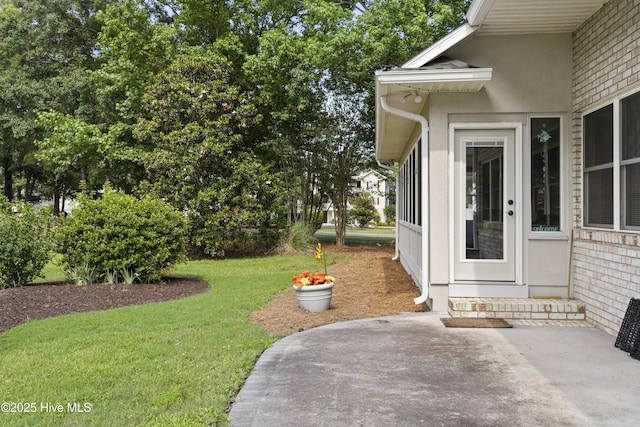 102 Crooked Gulley Cir, Sunset Beach, NC 28468 - property entrance with a lawn and a patio
