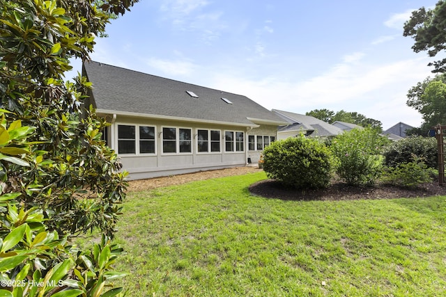 102 Crooked Gulley Cir, Sunset Beach, NC 28468 - back of house featuring a yard and a shingled roof