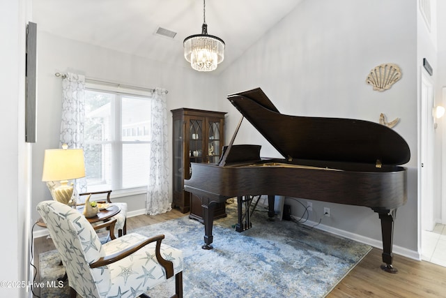 102 Crooked Gulley Cir, Sunset Beach, NC 28468 - sitting room featuring a chandelier, wood finished floors, and vaulted ceiling