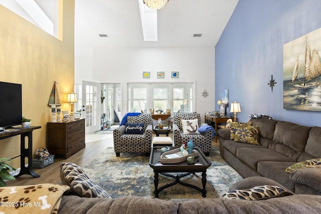 102 Crooked Gulley Cir, Sunset Beach, NC 28468 - living area featuring high vaulted ceiling, wood finished floors, and a skylight