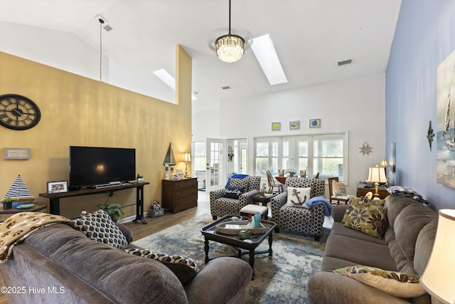 102 Crooked Gulley Cir, Sunset Beach, NC 28468 - living room featuring high vaulted ceiling, wood finished floors, and a skylight