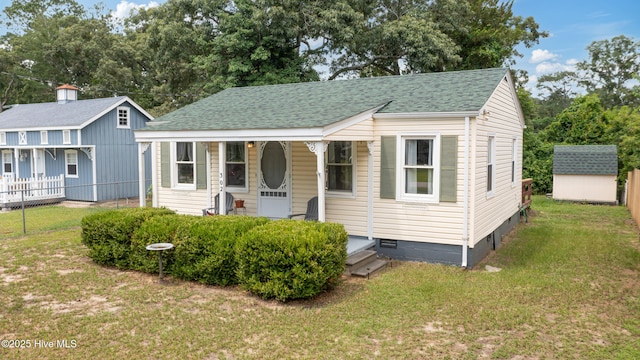 302 Roanoke Trl, Edenton, NC 27932 - bungalow featuring a shingled roof, covered porch, and a storage unit