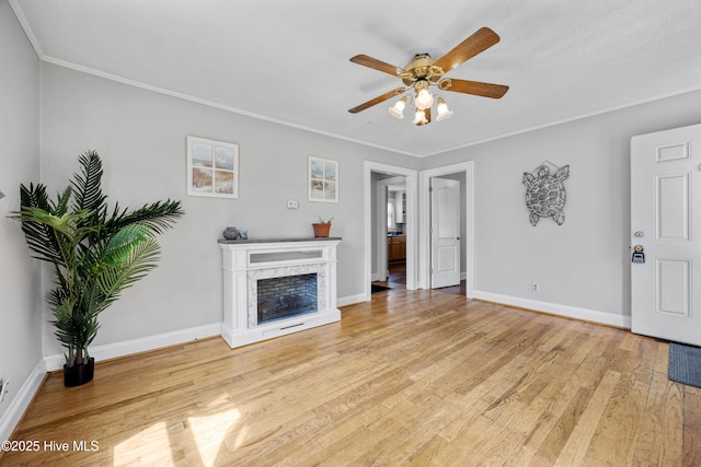 302 Roanoke Trl, Edenton, NC 27932 - unfurnished living room featuring a ceiling fan, light wood finished floors, a high end fireplace, and crown molding