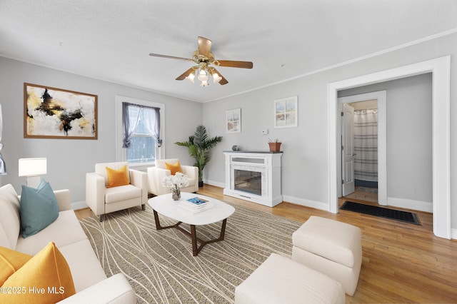 302 Roanoke Trl, Edenton, NC 27932 - living area featuring wood finished floors, ceiling fan, a high end fireplace, and crown molding