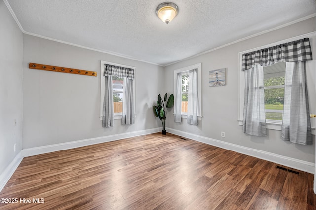 302 Roanoke Trl, Edenton, NC 27932 - empty room with a textured ceiling, ornamental molding, and wood finished floors