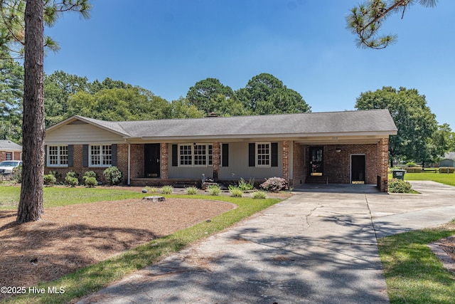 108 Perry Dr, Goldsboro, NC 27530 - ranch-style home with brick siding, driveway, an attached carport, and a front yard