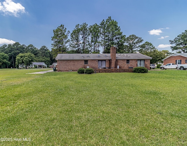 108 Perry Dr, Goldsboro, NC 27530 - back of property featuring a chimney, a yard, and brick siding