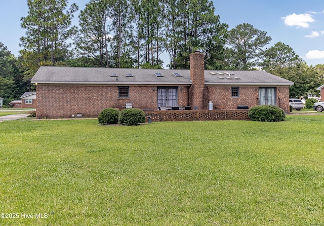 108 Perry Dr, Goldsboro, NC 27530 - rear view of property featuring brick siding, a yard, a chimney, and roof with shingles