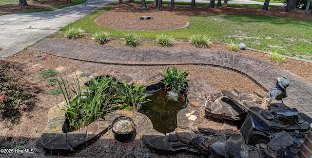108 Perry Dr, Goldsboro, NC 27530 - view of grassy yard featuring a garden pond