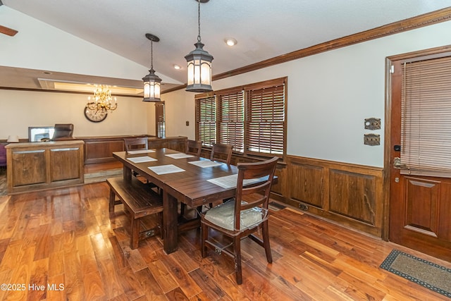 108 Perry Dr, Goldsboro, NC 27530 - dining area with ornamental molding, a wainscoted wall, light wood-style floors, lofted ceiling, and a chandelier