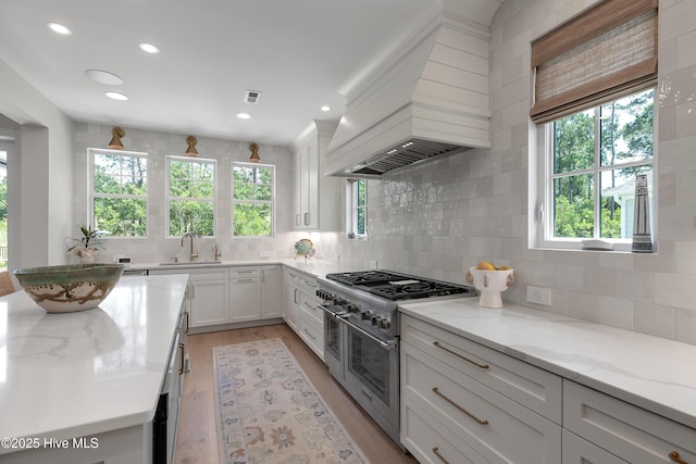 4139 Cobleskill Dr, Leland, NC 28451 - kitchen featuring double oven range, backsplash, white cabinetry, and recessed lighting