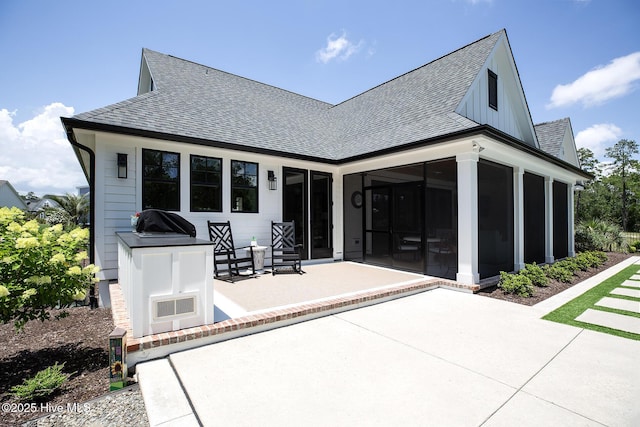 4139 Cobleskill Dr, Leland, NC 28451 - back of property with a patio, roof with shingles, and a sunroom