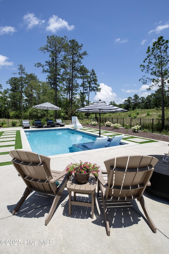 4139 Cobleskill Dr, Leland, NC 28451 - view of pool featuring a patio area and view of wooded area