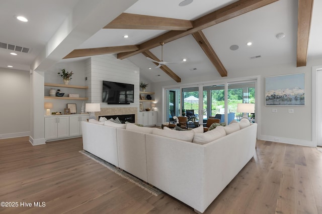 4139 Cobleskill Dr, Leland, NC 28451 - living room featuring a ceiling fan, light wood-style flooring, a large fireplace, beam ceiling, and recessed lighting