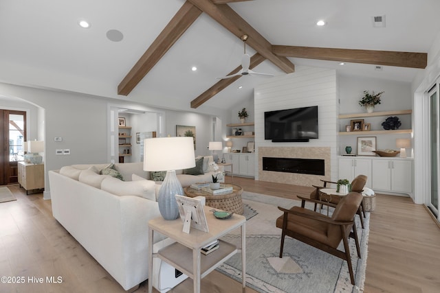 4139 Cobleskill Dr, Leland, NC 28451 - living area with ceiling fan, light wood-style flooring, arched walkways, recessed lighting, and a large fireplace