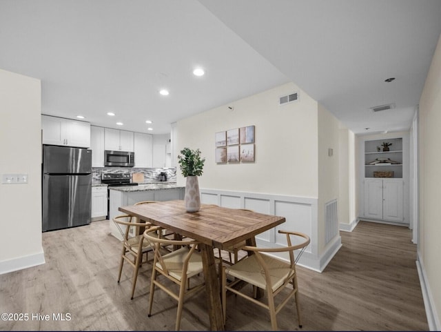 1896 New River Inlet Rd Unit 1310, North Topsail Beach, NC 28460 - dining room featuring light wood-style flooring, recessed lighting, and built in features