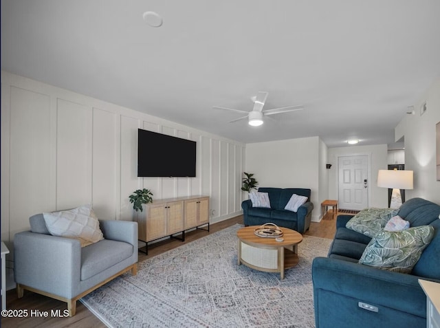 1896 New River Inlet Rd Unit 1310, North Topsail Beach, NC 28460 - living room featuring a decorative wall, wood finished floors, and ceiling fan